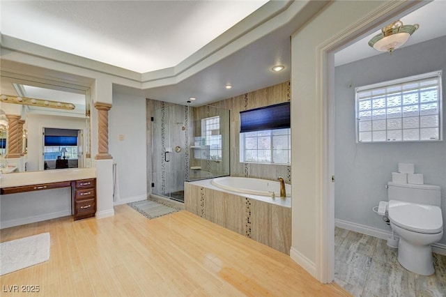 full bathroom with hardwood / wood-style flooring, vanity, toilet, and independent shower and bath