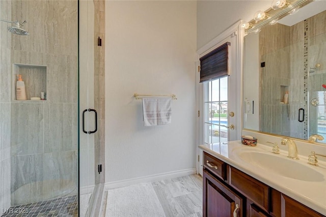 bathroom featuring walk in shower and vanity