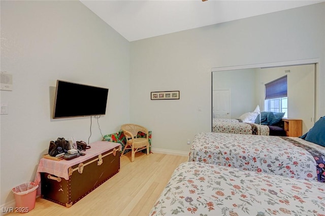 bedroom with hardwood / wood-style flooring and vaulted ceiling