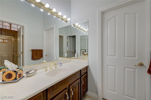 bathroom featuring vanity and an enclosed shower