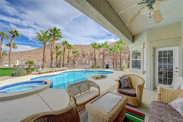 view of swimming pool with a mountain view, a patio, ceiling fan, and an in ground hot tub