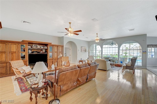 living room featuring light hardwood / wood-style flooring and ceiling fan