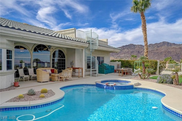 view of swimming pool featuring an in ground hot tub, a mountain view, and a patio