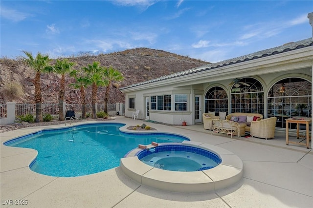 view of pool featuring a mountain view, an outdoor hangout area, a patio, and an in ground hot tub