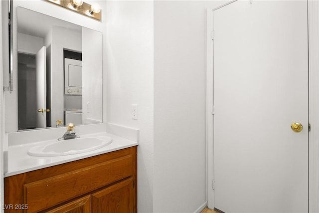 bathroom with vanity and stacked washing maching and dryer