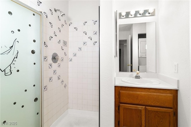 bathroom featuring tiled shower and vanity