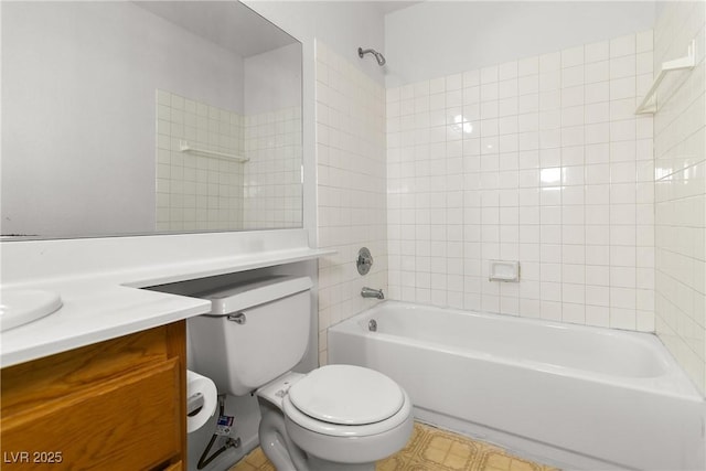 full bathroom featuring vanity, tiled shower / bath combo, and toilet