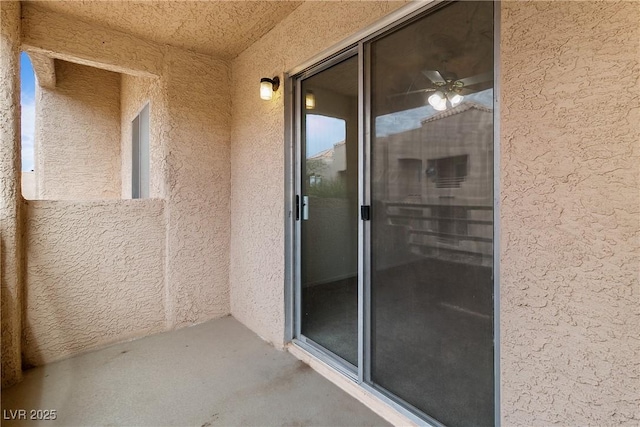 view of exterior entry featuring a balcony