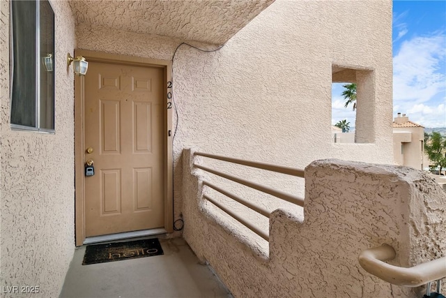 entrance to property with a balcony