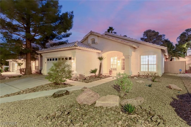 mediterranean / spanish-style house with a garage