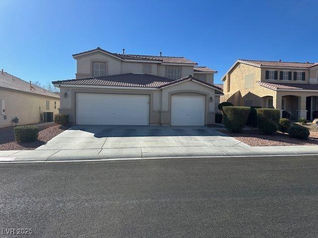 mediterranean / spanish-style home with cooling unit and a garage