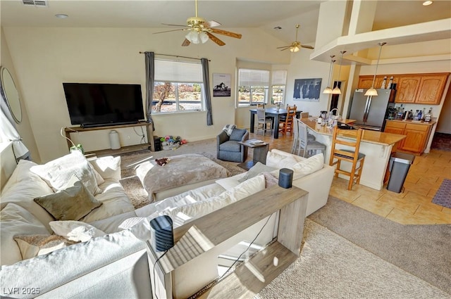 tiled living room featuring high vaulted ceiling and ceiling fan