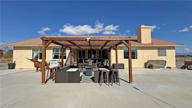 back of property featuring a patio, an outdoor kitchen, an outdoor hangout area, and a pergola