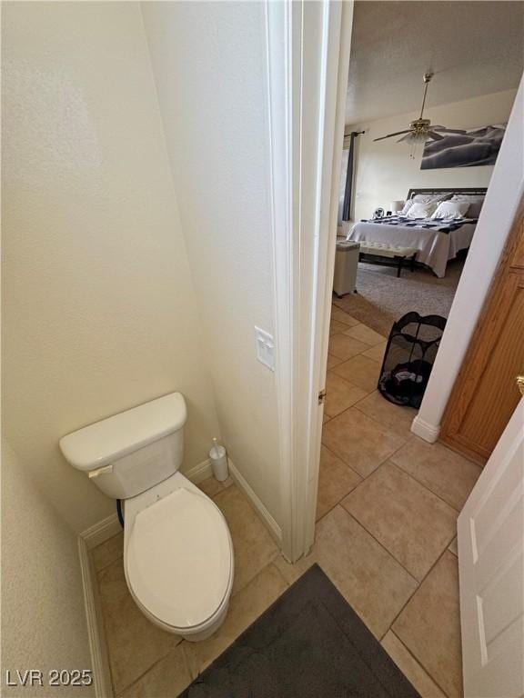 bathroom with ceiling fan, toilet, and tile patterned flooring