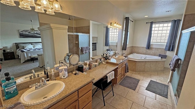 bathroom with ceiling fan, vanity, a textured ceiling, tile patterned floors, and shower with separate bathtub