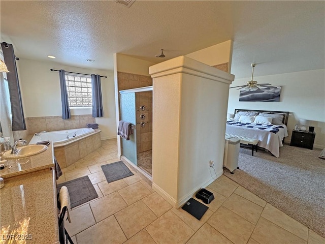 bathroom with independent shower and bath, ceiling fan, tile patterned flooring, and a textured ceiling