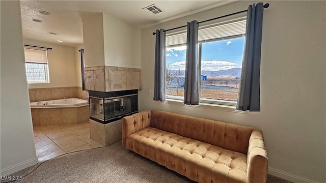 living area with carpet floors and a tile fireplace