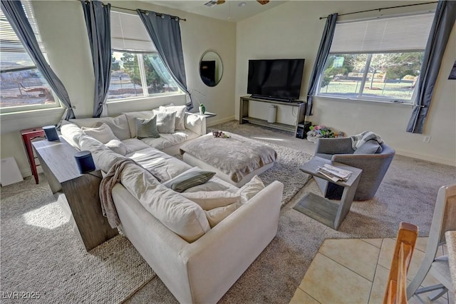 carpeted living room featuring vaulted ceiling and ceiling fan