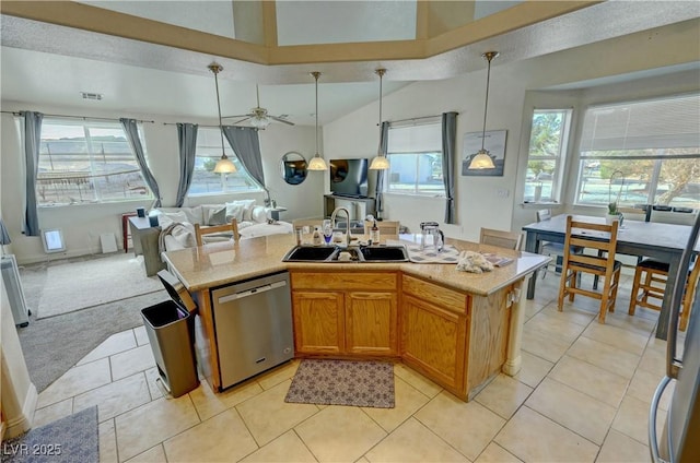 kitchen with sink, hanging light fixtures, a kitchen island with sink, stainless steel dishwasher, and light carpet