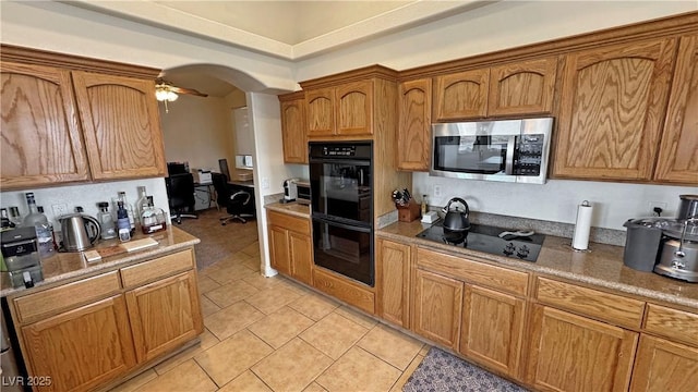 kitchen with light tile patterned flooring, ceiling fan, and black appliances