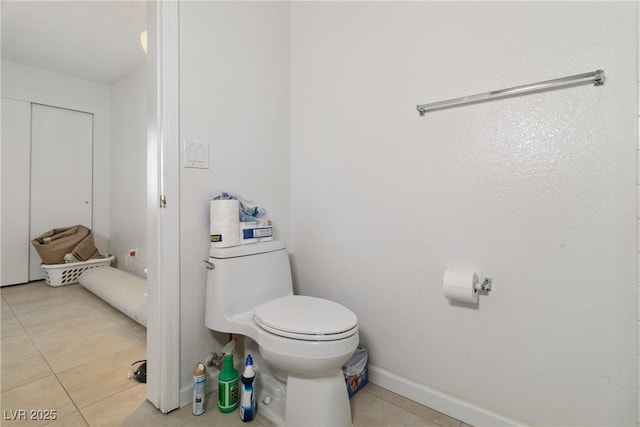 bathroom featuring toilet and tile patterned flooring