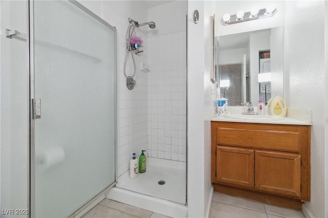 bathroom featuring walk in shower, tile patterned floors, and vanity