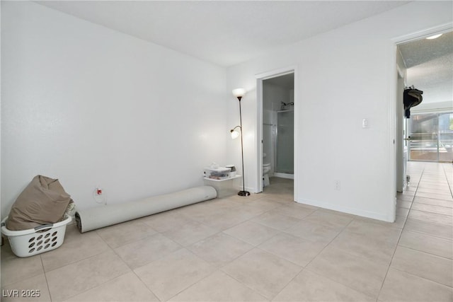 tiled bedroom featuring a spacious closet