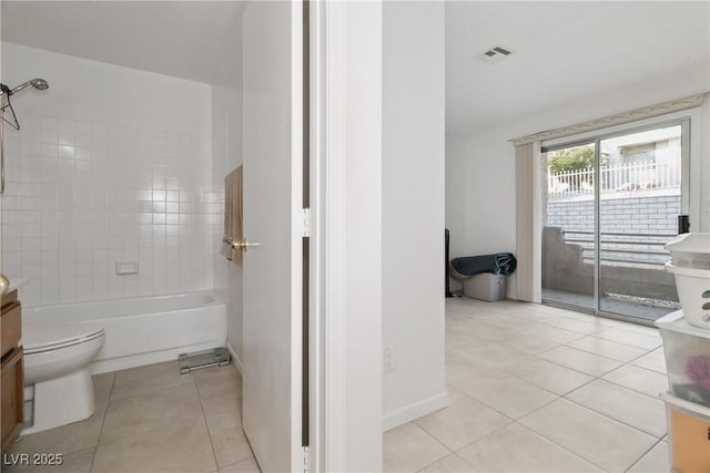 full bathroom featuring vanity, toilet, tiled shower / bath combo, and tile patterned flooring