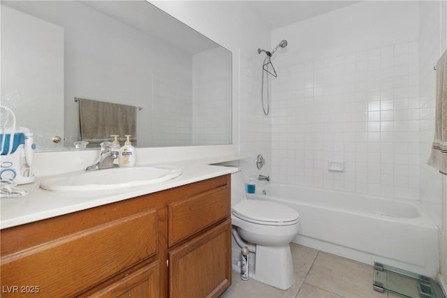 full bathroom featuring tile patterned flooring, vanity, tiled shower / bath combo, and toilet