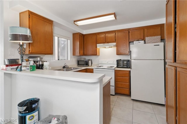 kitchen with sink, light tile patterned floors, white appliances, and kitchen peninsula