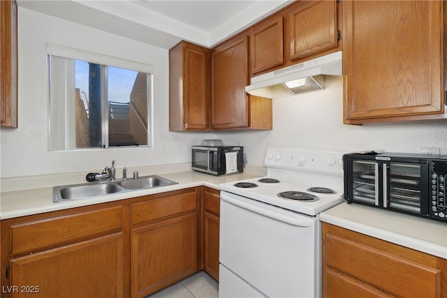 kitchen with light tile patterned flooring, sink, and white range with electric stovetop