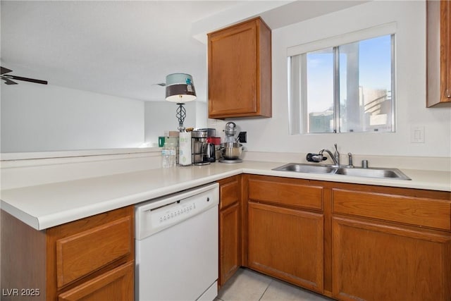 kitchen featuring dishwasher, sink, light tile patterned floors, and ceiling fan