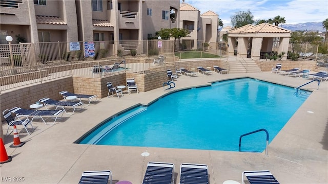 view of pool featuring a mountain view and a patio area