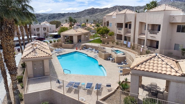 view of pool with a mountain view and a patio area