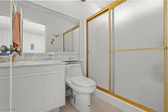 bathroom with a shower stall, toilet, and vanity