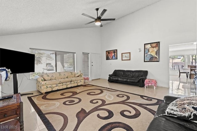 living room featuring a textured ceiling, high vaulted ceiling, and ceiling fan