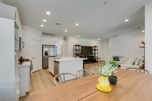 dining area featuring sink and light hardwood / wood-style flooring