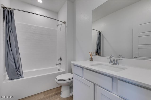 full bathroom with vanity, toilet, hardwood / wood-style floors, and shower / bath combo with shower curtain