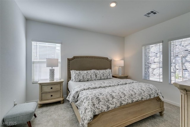 carpeted bedroom featuring multiple windows