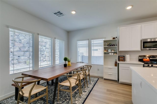 dining space featuring light wood-type flooring