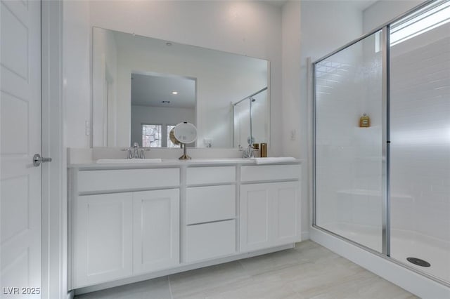 bathroom featuring vanity and a shower with shower door