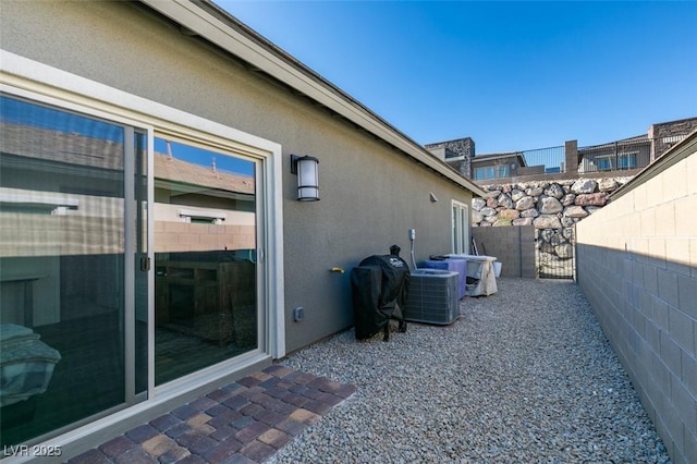 view of patio with a grill and central AC unit