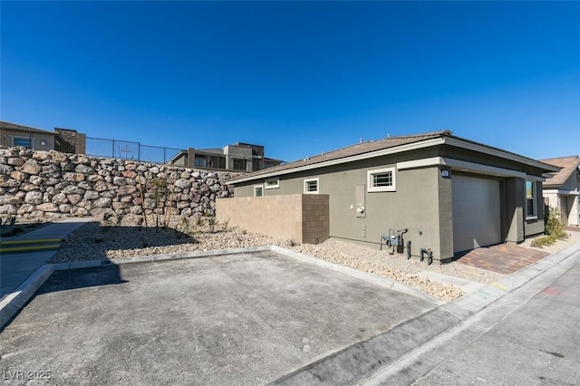 view of side of property featuring a garage