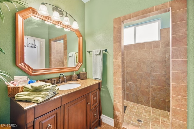 bathroom featuring vanity and tiled shower