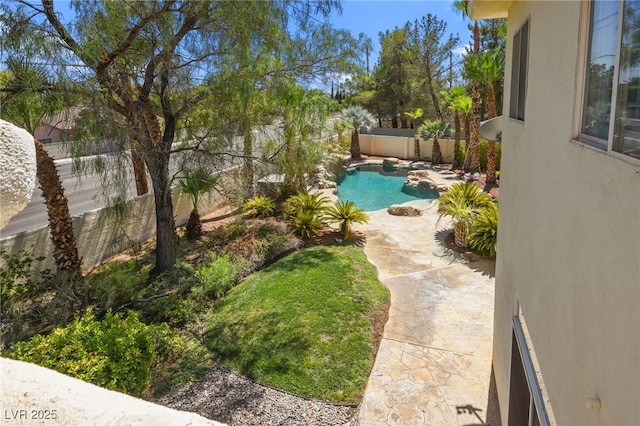 view of yard with a fenced in pool and a patio