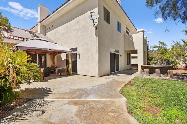 back of property featuring an outdoor living space, a gazebo, a yard, and a patio