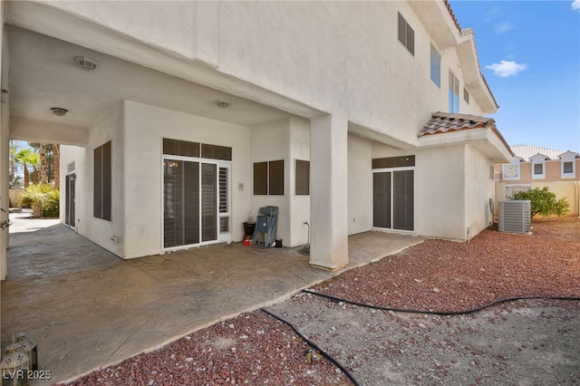 rear view of property featuring cooling unit and a patio