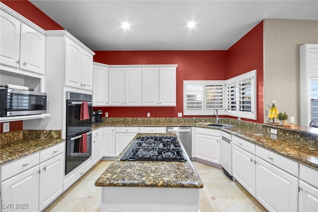 kitchen with white cabinetry, dark stone counters, sink, and black appliances