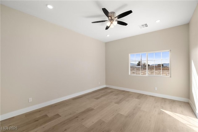 spare room with light hardwood / wood-style flooring and ceiling fan