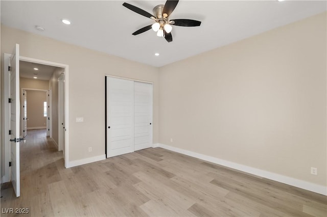 unfurnished bedroom featuring ceiling fan, light hardwood / wood-style floors, and a closet